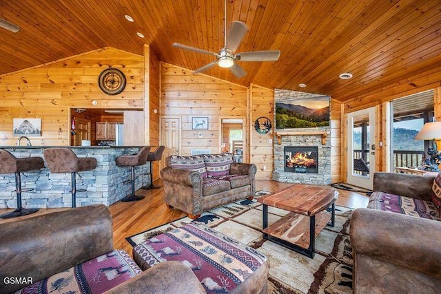 living area featuring wood ceiling, lofted ceiling, and wood finished floors