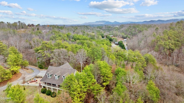 birds eye view of property featuring a mountain view and a forest view