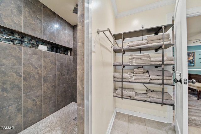 full bath featuring baseboards, ornamental molding, walk in shower, and tile patterned floors