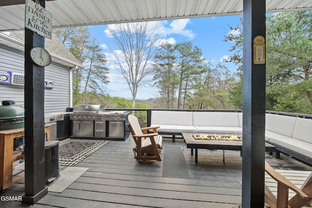 wooden terrace with an outdoor living space with a fire pit, exterior kitchen, and a grill
