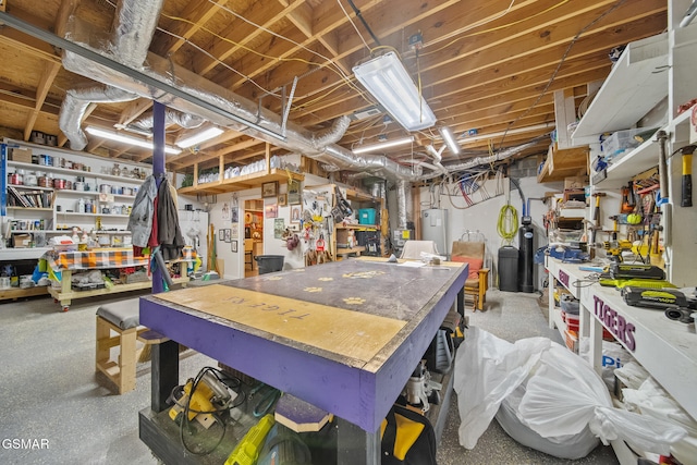 unfinished basement featuring water heater and a workshop area