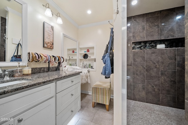 bathroom featuring crown molding, walk in shower, tile patterned flooring, and vanity