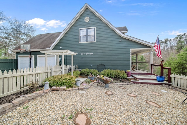 rear view of house featuring fence
