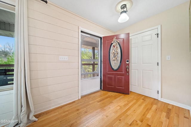entrance foyer with baseboards and light wood-style flooring
