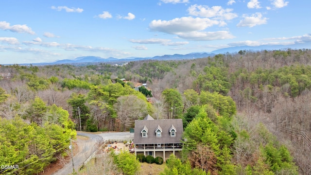 aerial view featuring a view of trees and a mountain view