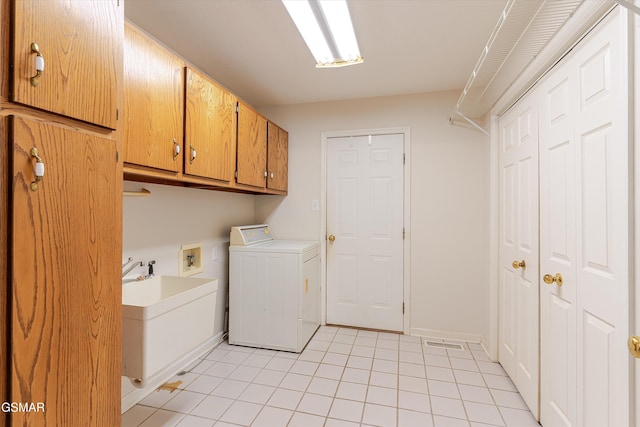 washroom featuring light tile patterned floors, baseboards, washer / dryer, cabinet space, and a sink