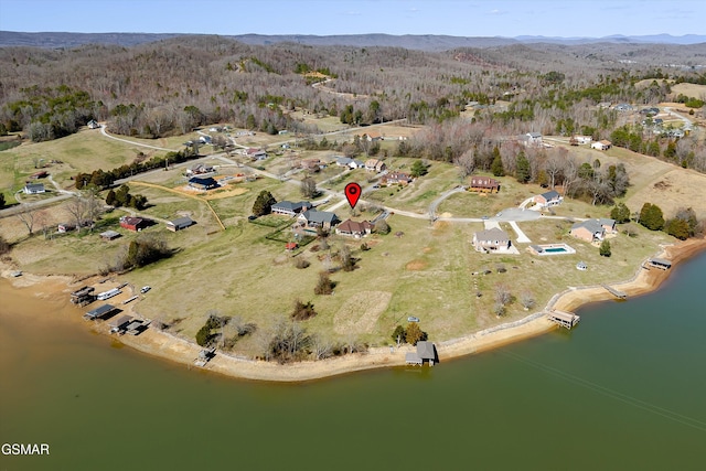 birds eye view of property with a water and mountain view