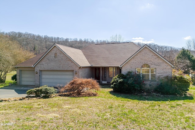 ranch-style house with brick siding, an attached garage, concrete driveway, and a front yard