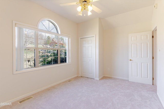 unfurnished bedroom featuring visible vents, carpet floors, baseboards, and a closet