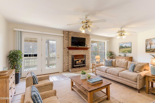 living area with ceiling fan and a fireplace