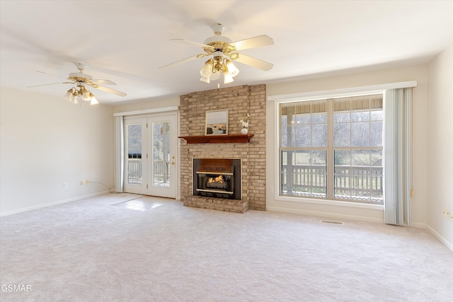 unfurnished living room with a wealth of natural light, baseboards, carpet, and a fireplace