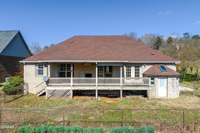 rear view of property featuring a yard, a fenced backyard, brick siding, and a shingled roof