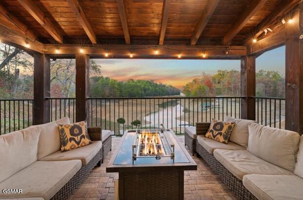 sunroom featuring beamed ceiling and wood ceiling