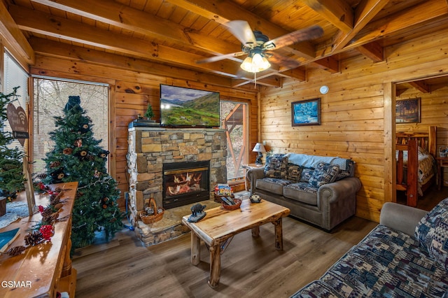 331 Caney Creek Rd, Pigeon Forge, TN 37863 - living area featuring a wooden ceiling with exposed beams, ceiling fan, wood finished floors, wood walls, and a fireplace