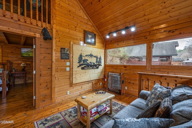 331 Caney Creek Rd, Pigeon Forge, TN 37863 - living room with wooden walls, hardwood / wood-style flooring, wood ceiling, plenty of natural light, and high vaulted ceiling