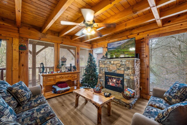 331 Caney Creek Rd, Pigeon Forge, TN 37863 - living room with a wooden ceiling with exposed beams, wood walls, wood finished floors, a ceiling fan, and a fireplace