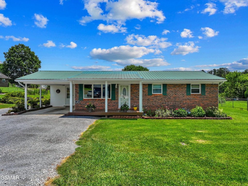 189 Terry St, Newport, TN 37821 - ranch-style home featuring brick siding, a porch, driveway, a metal roof, and an attached carport
