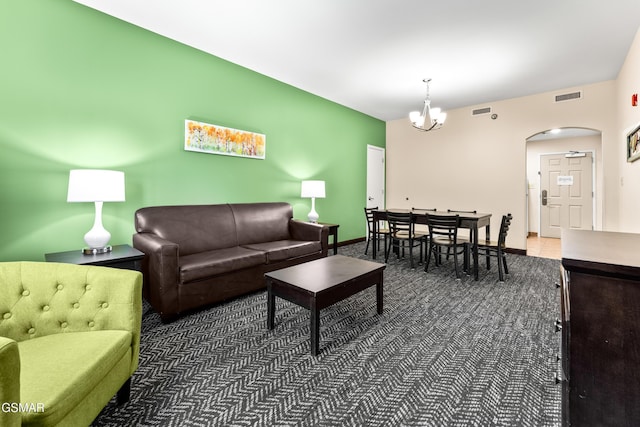 carpeted living room featuring a notable chandelier