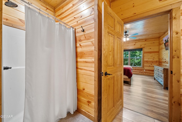 646 Stockton Dr, Sevierville, TN 37876 - full bathroom with wood finished floors, wood walls, a shower with curtain, ceiling fan, and wooden ceiling
