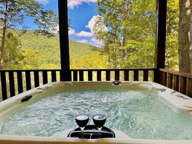 deck featuring a hot tub