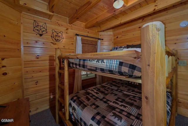 bedroom with beam ceiling, wood ceiling, and wood walls