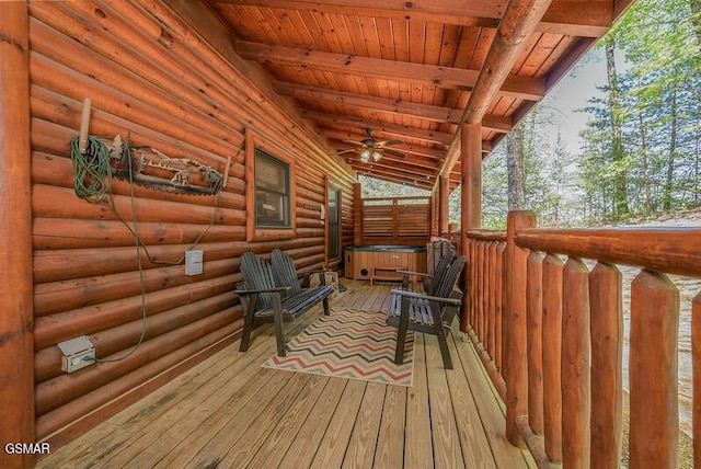 wooden terrace featuring a hot tub and ceiling fan