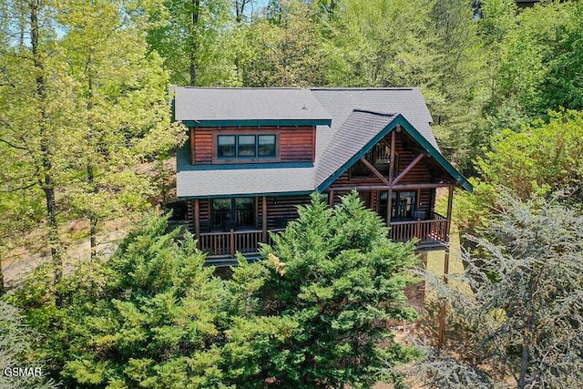 log-style house featuring a view of trees