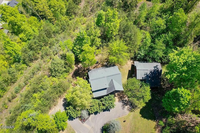 drone / aerial view with a wooded view