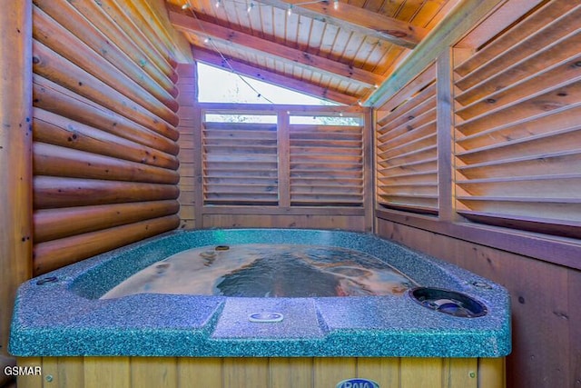 misc room with lofted ceiling with beams, a jacuzzi, log walls, and wooden ceiling