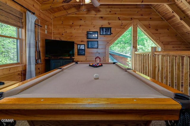 rec room featuring wood walls, wooden ceiling, lofted ceiling with beams, and a ceiling fan