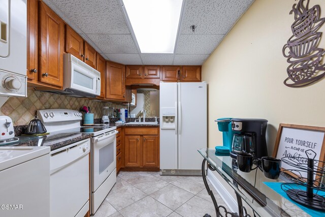 3215 N River Rd Ste 503, Pigeon Forge, TN 37863 - kitchen featuring decorative backsplash, a drop ceiling, white appliances, sink, and light tile patterned flooring