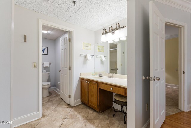 3215 N River Rd Ste 503, Pigeon Forge, TN 37863 - bathroom featuring tile patterned floors, a paneled ceiling, vanity, and toilet
