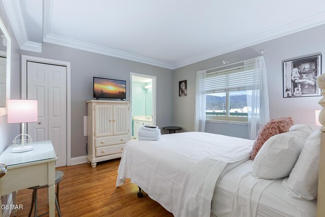 3215 N River Rd Ste 503, Pigeon Forge, TN 37863 - bedroom featuring wood-type flooring, ensuite bath, and ornamental molding