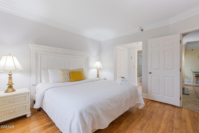 3215 N River Rd Ste 503, Pigeon Forge, TN 37863 - bedroom with wood-type flooring, ensuite bath, and ornamental molding