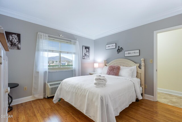 3215 N River Rd Ste 503, Pigeon Forge, TN 37863 - bedroom with a wall mounted air conditioner, wood-type flooring, and ornamental molding