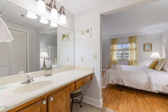 3215 N River Rd Ste 503, Pigeon Forge, TN 37863 - bathroom with crown molding, hardwood / wood-style floors, and vanity
