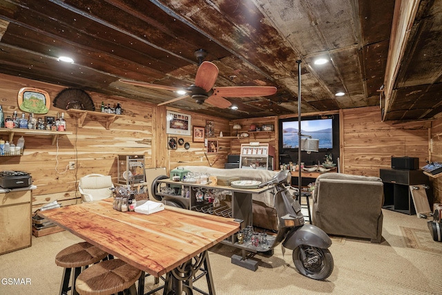 interior space with ceiling fan, wooden ceiling, and wood walls