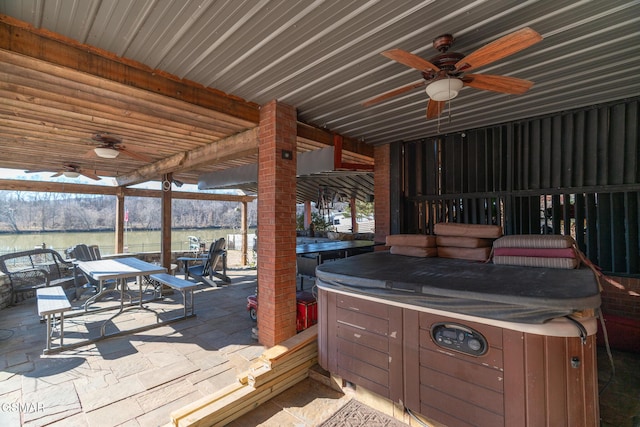 wooden terrace with ceiling fan, a hot tub, and a patio area