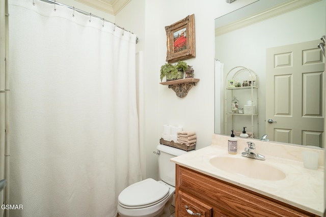 bathroom featuring vanity, ornamental molding, and toilet