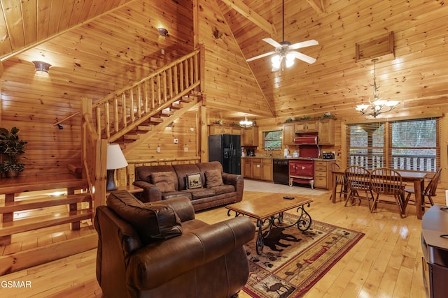 living room with wood ceiling, wood walls, light wood-type flooring, and stairs