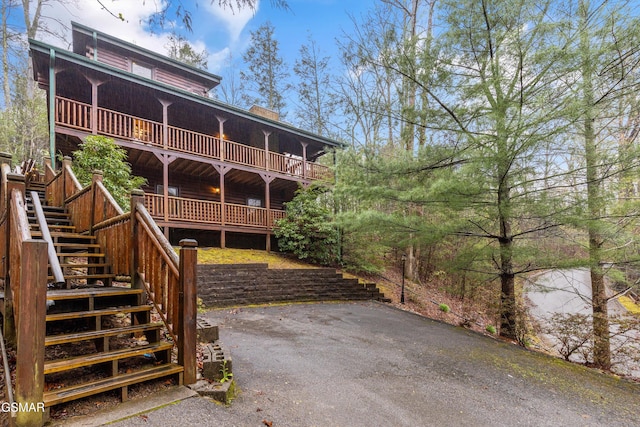 rear view of property with stairway