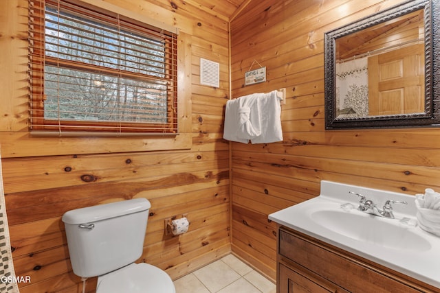full bathroom with toilet, wood walls, tile patterned flooring, and vanity