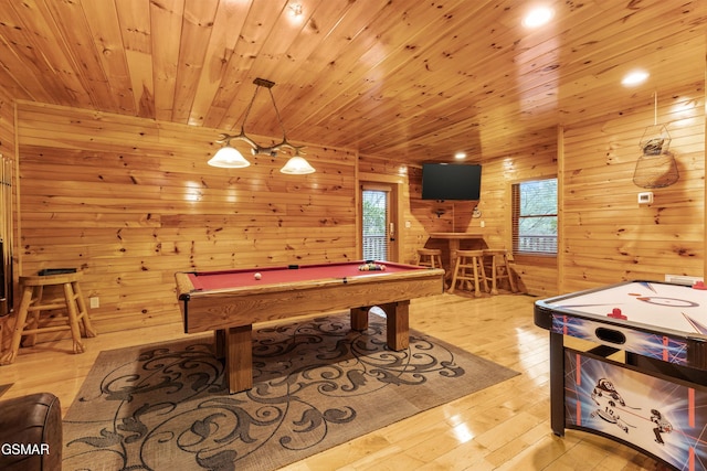 game room featuring light wood-type flooring, wooden ceiling, wooden walls, and pool table