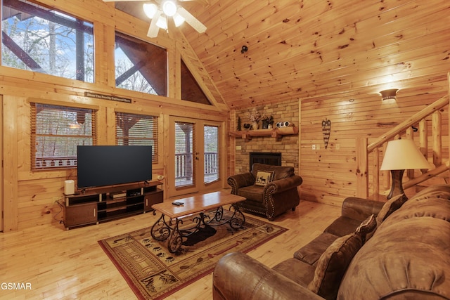 living area featuring wooden walls, a ceiling fan, high vaulted ceiling, hardwood / wood-style flooring, and wooden ceiling