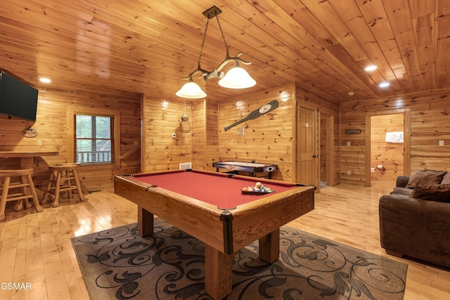 recreation room featuring light wood finished floors, wood ceiling, billiards, and wooden walls