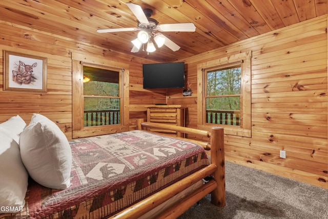 carpeted bedroom featuring wooden walls and wooden ceiling