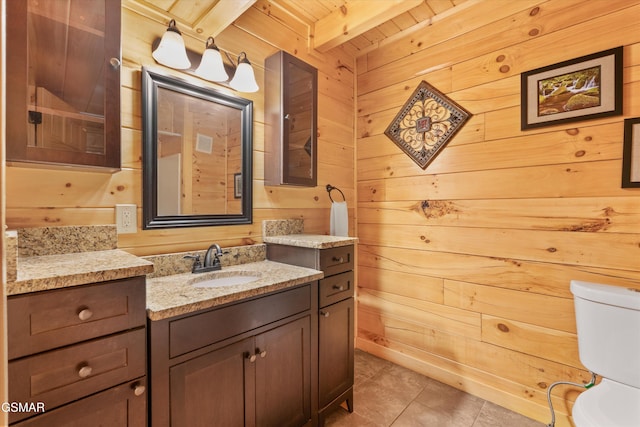 2377 Alpine Village Way, Pigeon Forge, TN 37863 - bathroom with toilet, vanity, tile patterned flooring, wooden walls, and wooden ceiling with exposed beams