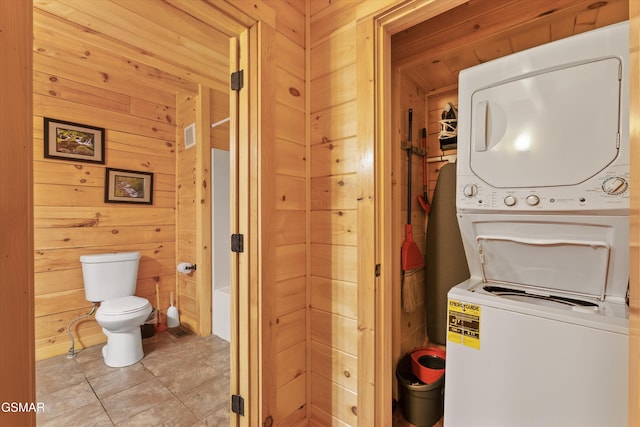 2377 Alpine Village Way, Pigeon Forge, TN 37863 - washroom with stacked washer and clothes dryer, wooden walls, and light tile patterned flooring