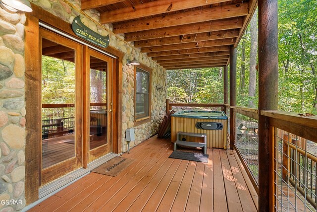 wooden deck featuring a hot tub