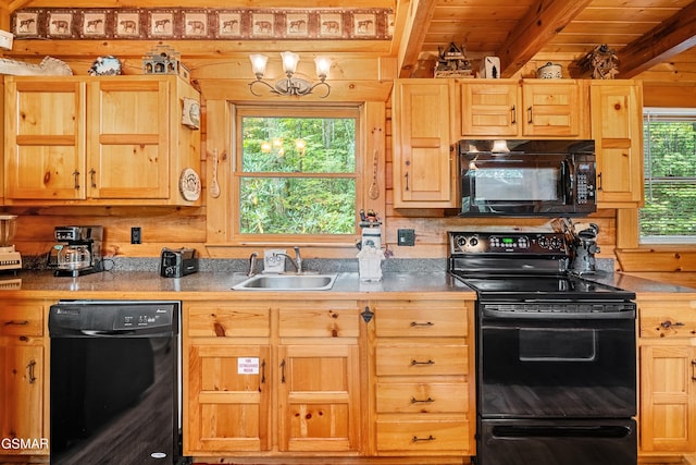 kitchen with beamed ceiling, sink, a healthy amount of sunlight, and black appliances